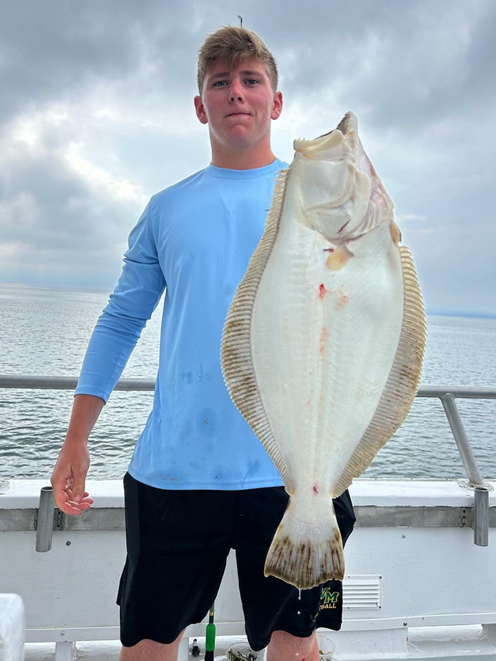 Angler with large fluke catch on Celtic Quest charter boat
