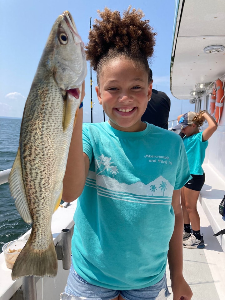 Your First Fishing Charter: Everything You Need to Know 3 Young girl holding weakfish catch on Celtic Quest fishing trip
